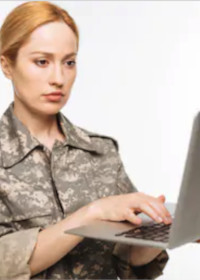 US military woman typing on a laptop