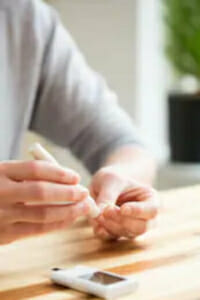 Person using a lancet to check blood sugar